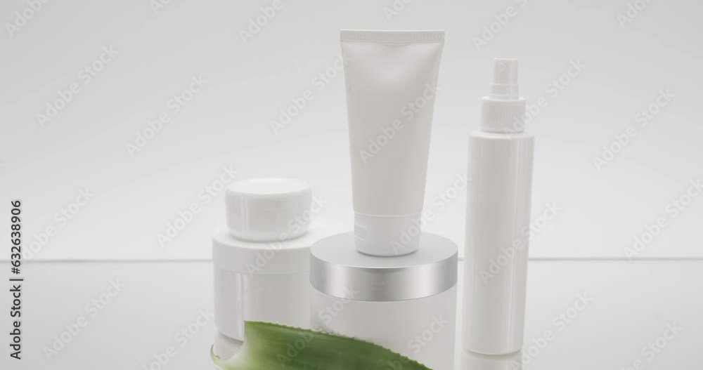 Natural cosmetics production for hair and skin care. Glossy cosmetic jar with cream. Different cosmetic bottles. Jars, bottles and tubes for cosmetics and Beauty treatment on a white background. Natural cosmetics production for hair and skin care. Glossy cosmetic jar with cream. Different cosmetic bottles. Jars, bottles and tubes for cosmetics and Beauty treatment on a white background.