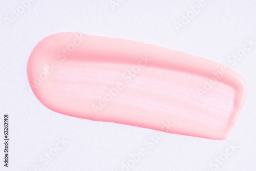 Light pink paint swatch on white paper background. Peach color swatch of lip gloss, cosmetic product stroke gouache, oil paint texture, cosmetic or beauty product texture.