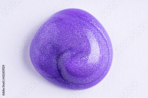 Lilac cosmetic cream smear on white background. Violet beauty cream smear swipe swatch closeup. Lavender face serum, lotion, moisturizer on white. Light purple paint swatch.