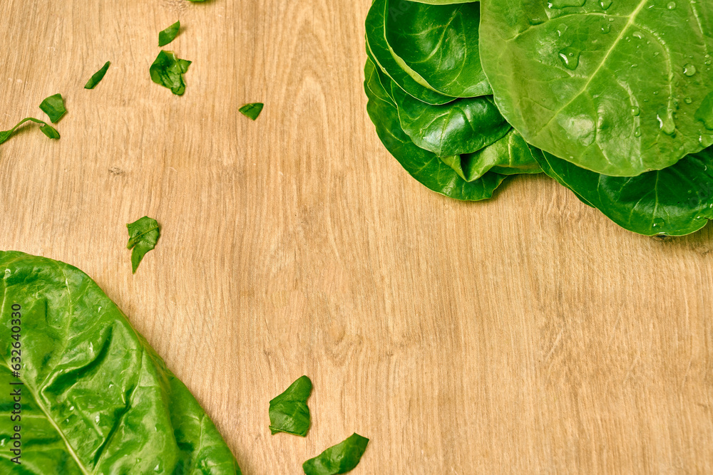 Fresh spinach leaves on a wooden cutting board Fresh spinach leaves on a wooden cutting board