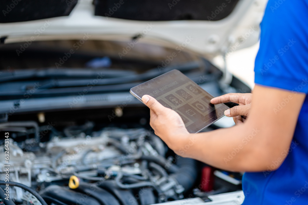 Fototapeta premium Automotive mechanic repairmen use tablets and check the system working engine of the engine room, check the mileage of the car, oil change, auto maintenance service concept.