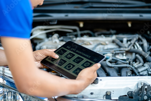 Automotive mechanic repairmen use tablets and check the system working engine of the engine room, check the mileage of the car, oil change, auto maintenance service concept.