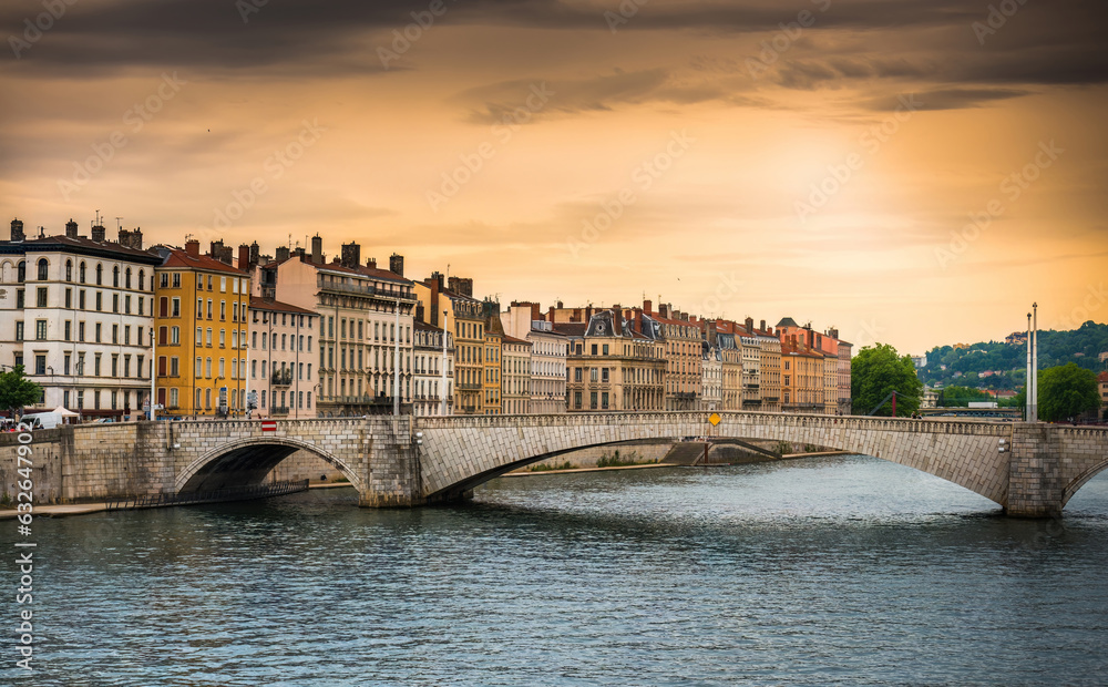 Amazing Sunset View from river Sona to the Bonaparte bridge and Lyon city, France
