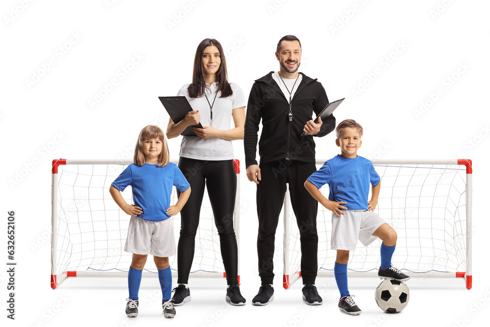Football coaches and children in front of a mini goal Football coaches and children in front of a mini goal