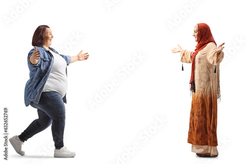 Overweight woman meeting and greeting a muslum young woman