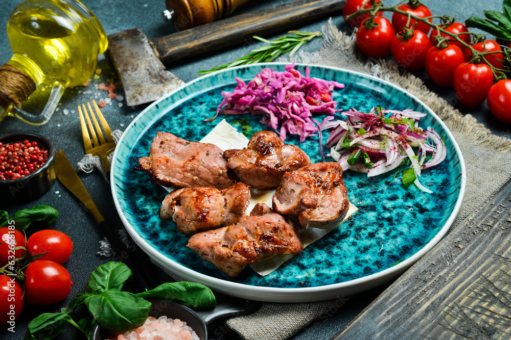 Grilled turkey meat kebabs. On a plate, served with fresh vegetables. Top view. Grilled turkey meat kebabs. On a plate, served with fresh vegetables. Top view.