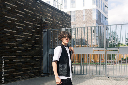 young man on the street against the urban landscape