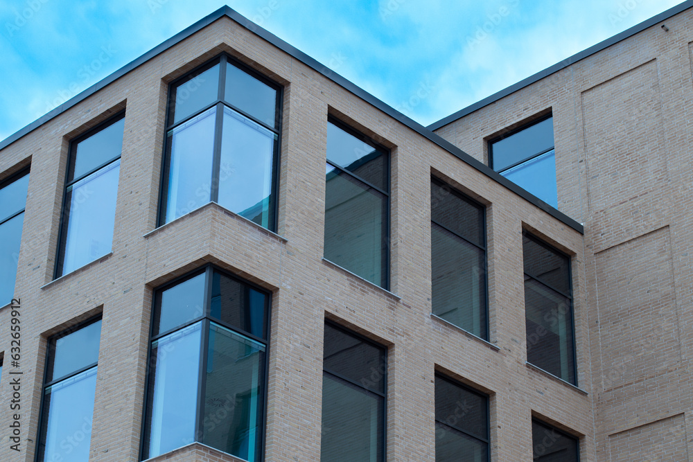 Modern office building in scandinavia with blue cloudy skies in the background. Modern office building in scandinavia with blue cloudy skies in the background.