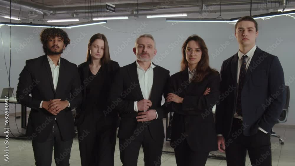 Diverse team of business people posing for a photo together. Successful team of businessmen in business suits are having a photo shoot in the office. Diverse team of business people posing for a photo together. Successful team of businessmen in business suits are having a photo shoot in the office.