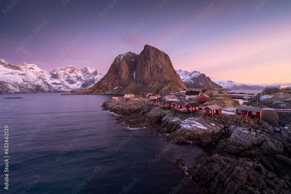Hamnoy: Quaint fishing village in Norway Lofoten Islands, famous for its iconic red cabins against stunning mountainous backdrops. High quality photo