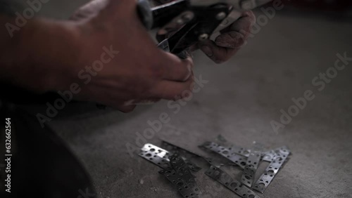 Builder uses metal scissors. Renovation in the apartment. photo