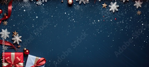 christmas decoration with Christmas fir branches, gift boxes with red ribbon, red decoration, sparkles and confetti on blue background. copy space banner background.