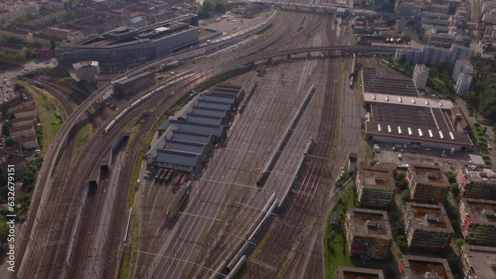 High angle view of extensive railway yard site with trains and depot. Crossing of multiple rail tracks. Zurich, Switzerland