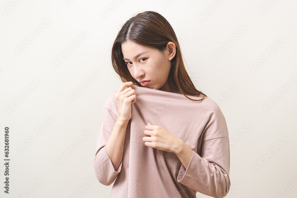Bad smelling, deodorant asian young woman smell stink, breathing nose smelly on shirt dirty stinky laundry, disgusting from clothes after washed, smelly armpit underarm Medical health, skin body care. Bad smelling, deodorant asian young woman smell stink, breathing nose smelly on shirt dirty stinky laundry, disgusting from clothes after washed, smelly armpit underarm Medical health, skin body care.