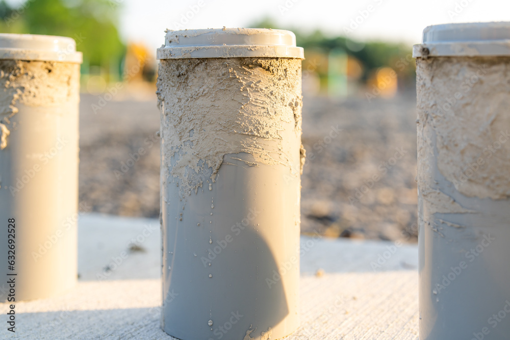 Naklejka premium Concrete Test Cylinders on a construction site.