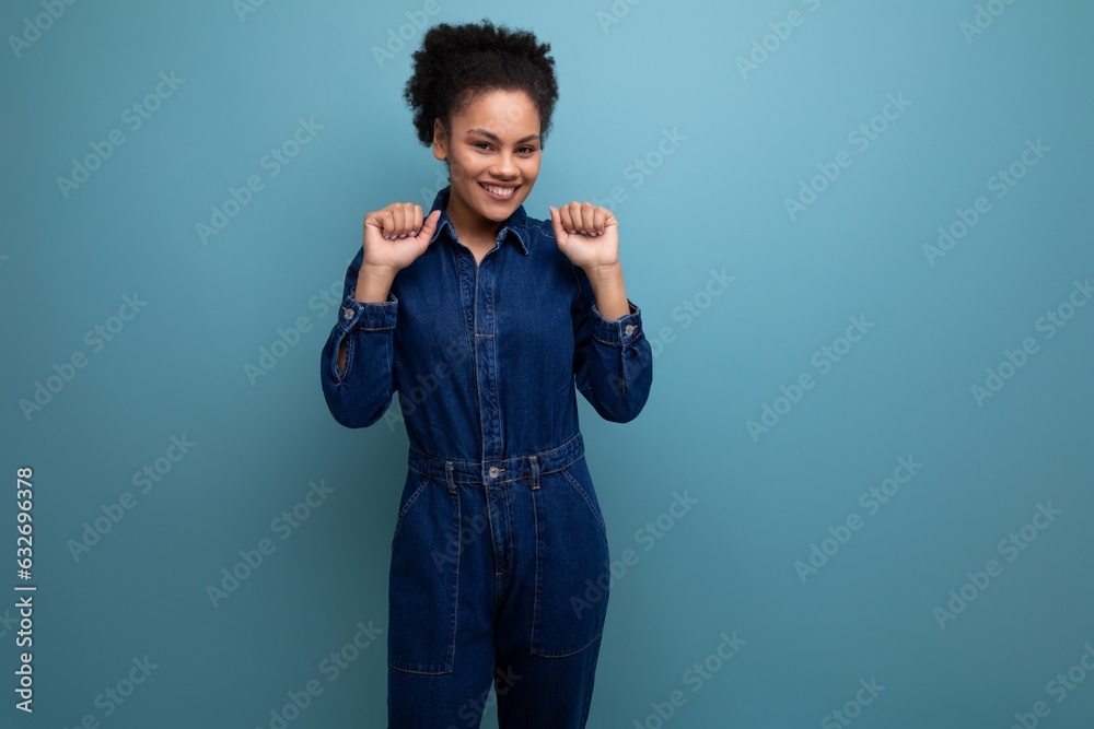 portrait of charming slim young hispanic brunette woman with fluffy curly hair in blue denim suit portrait of charming slim young hispanic brunette woman with fluffy curly hair in blue denim suit