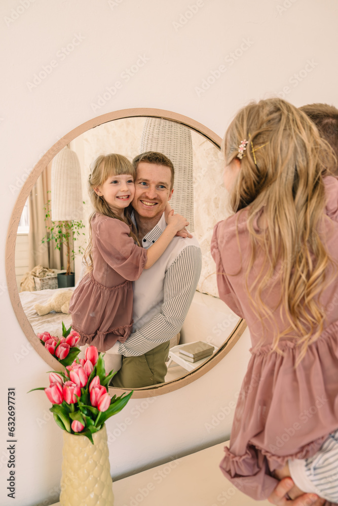 Fototapeta premium happy father with daughter reflection in the mirror