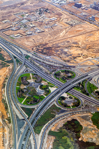 Aerial view of highway interchange. Road junction. Residential buildings  squares and streets in Oman