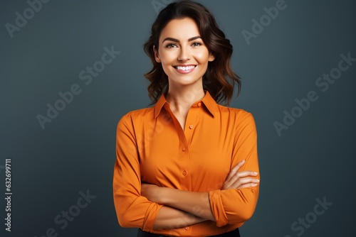 Attractive charming lady arms crossed in an orange blouse self-confident person worker friendly smile