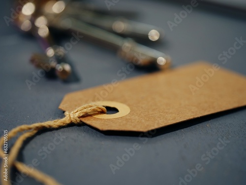 Brown address label tag with keys in background 