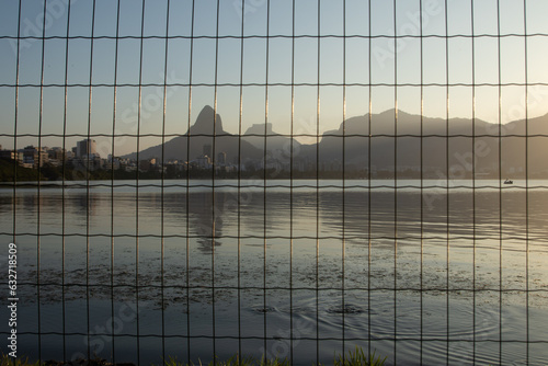 Rodrigo de Freitas lagoon  (Lagoa Rodrigo de Freitas) seen from behind the bars during sunset in Rio de Janeiro.