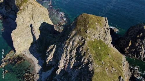 Aerial: a bird of prey flies at the Cape of Four Rocks in the Sea of Japan photo