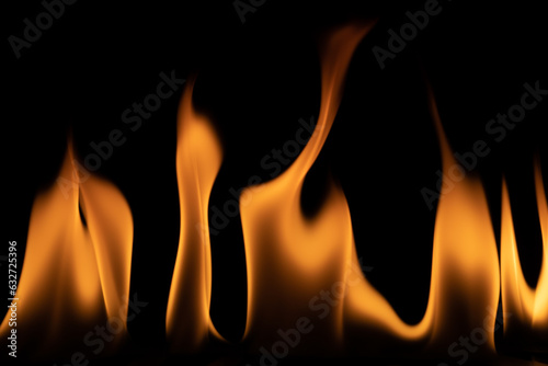 On a black background, flames are burning in the dark