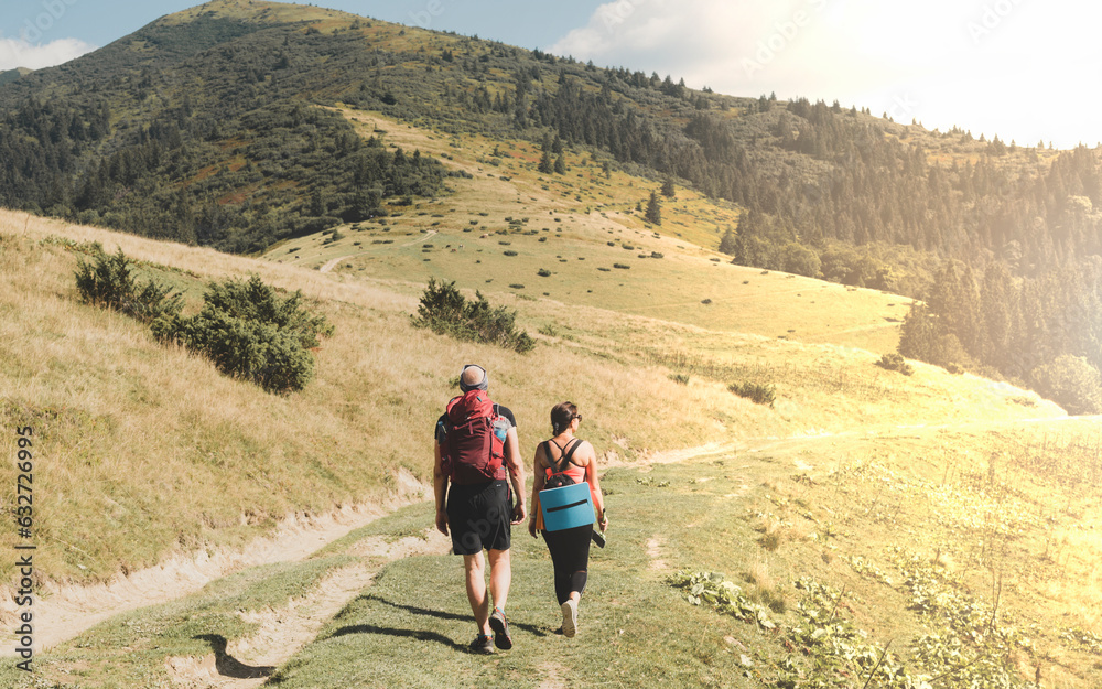 Happy couple hiking in the mountain peaks of the Carpathians