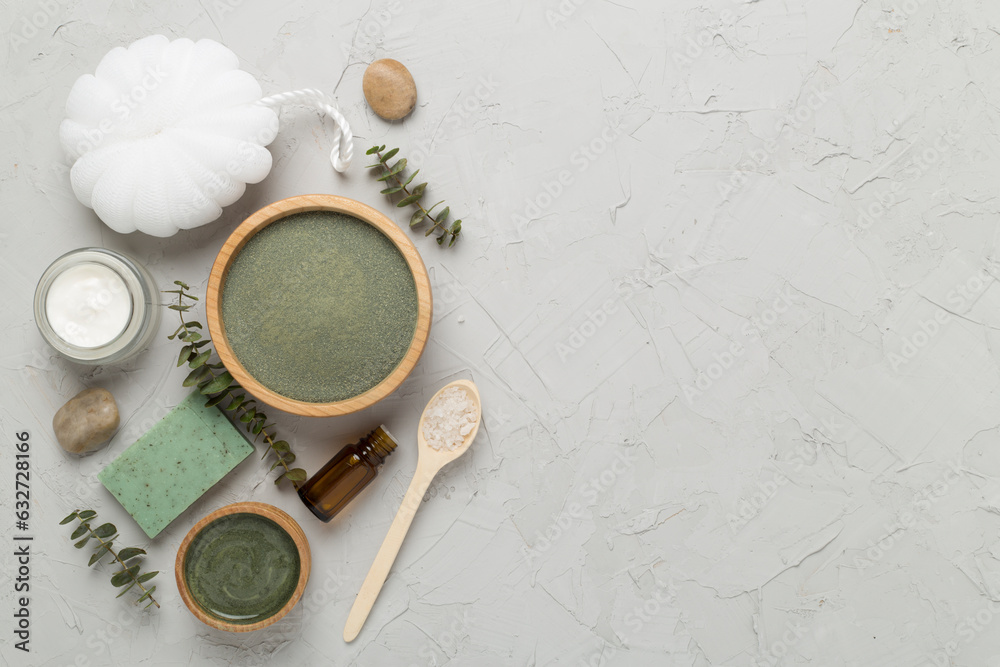 Composition with cosmetic clay and spa products on concrete background, top view Composition with cosmetic clay and spa products on concrete background, top view