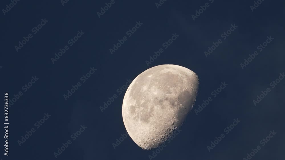 View of the moon in a Waning Gibbous phase as cloud move in front at dawn. View of the moon in a Waning Gibbous phase as cloud move in front at dawn.