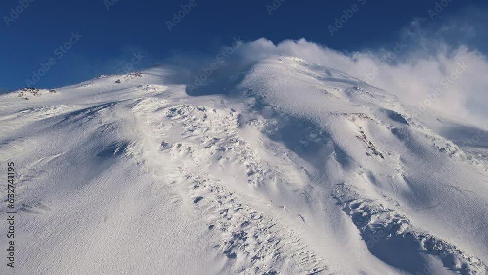 Mega tall white mountain with blowing snow Mega tall white mountain with blowing snow