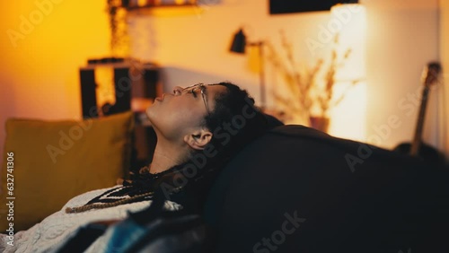 African American woman with braided hair coming back home late after long day photo