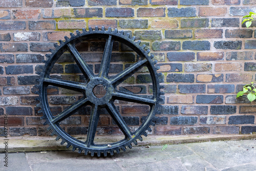 Huge, rusting abandoned flywheel from a Victorian era lifting engine and old Ironworks photo