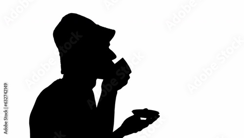 Black silhouette of a man drinking from a cup. black and white mask photo