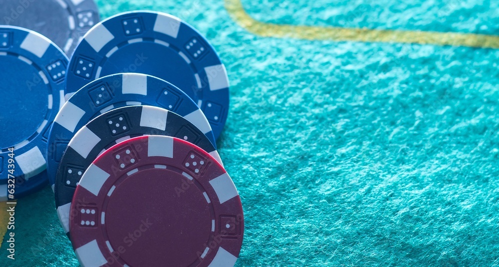 Naklejka premium Stack of casino chips or tokens on a numbered roulette board in payment of a bet in a gambling game of luck and chance