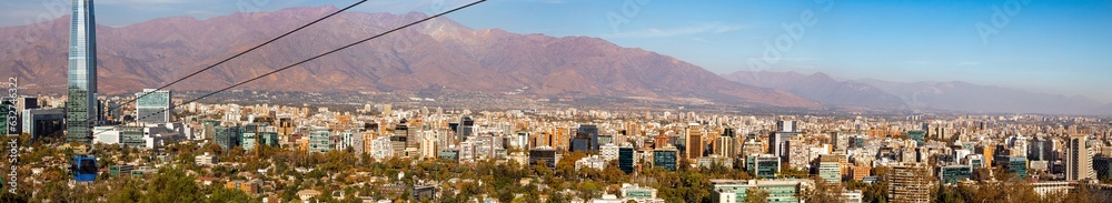 panorama of the city of Santiago Chile with its buildings, cable car and the Andes mountain range