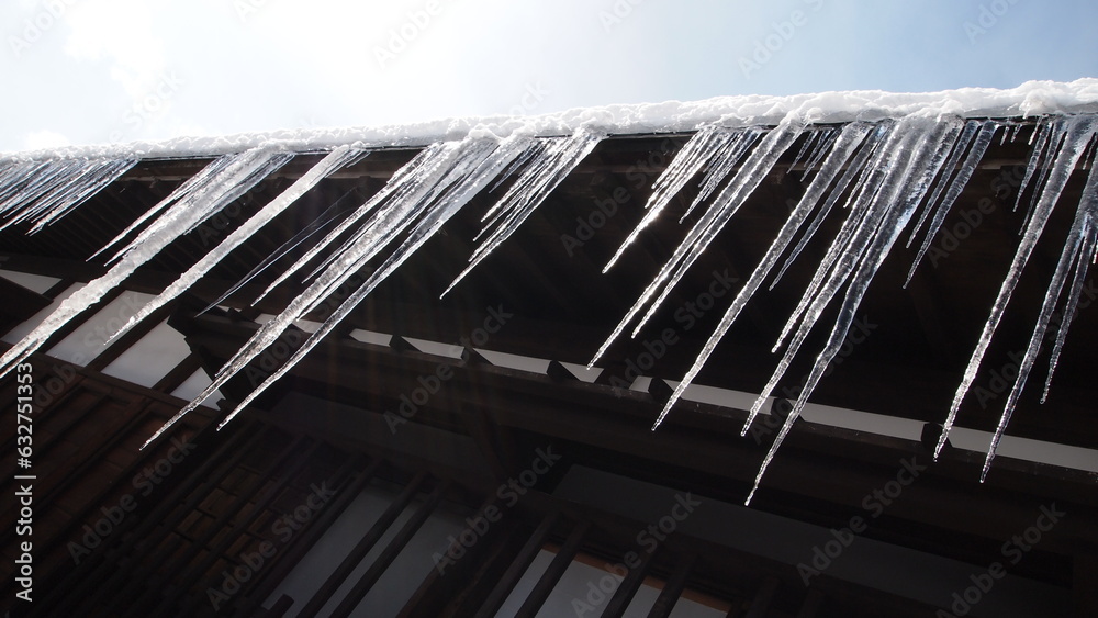 Fototapeta premium Frozen water icicles on a roof edge in Takayama Japan