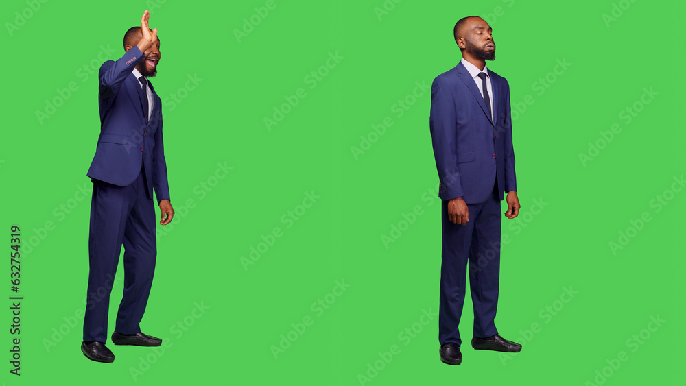 Businessman in suit greeting people and waving, saying hello or goodbye in studio over greenscreen. Male startup employee feeling confident on camera posing, full body backdrop. Businessman in suit greeting people and waving, saying hello or goodbye in studio over greenscreen. Male startup employee feeling confident on camera posing, full body backdrop.