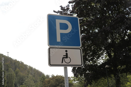 Parking sign for disabled people and people with a disability on a nature mountain forest background. 