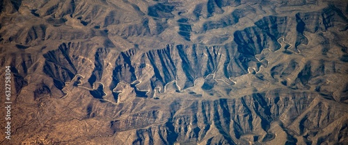 An aerial photo of a narrow winding road in the mountains of norther Guatemals