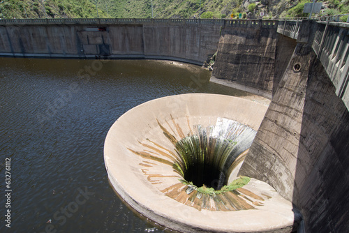 San Roque dam water funnel in Villa Carlos Paz, Cordoba, Argentina photo