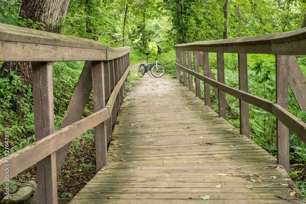 folding bike and footbridge - Katy Trail (side nature trail) near Rocheport, Missouri, in summer scenery