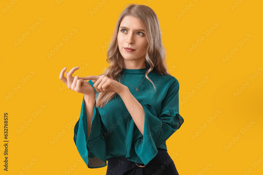 Young woman counting on yellow background Young woman counting on yellow background