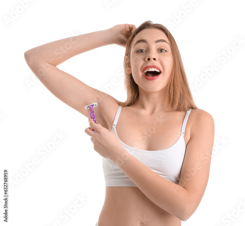 Young woman shaving armpits...