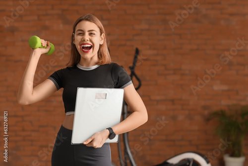 Happy young woman holding a...