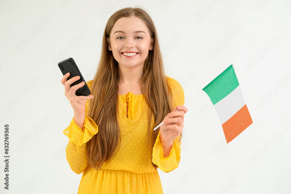 Pretty young woman with flag of Italy and mobile phone on white background Pretty young woman with flag of Italy and mobile phone on white background
