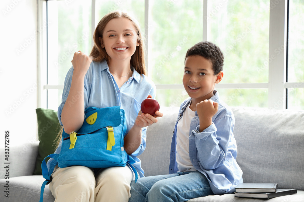 Happy African-American schoolboy with his mother at home Happy African-American schoolboy with his mother at home