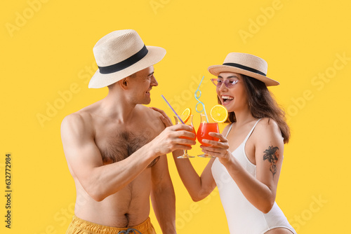 Happy couple toasting tropi...