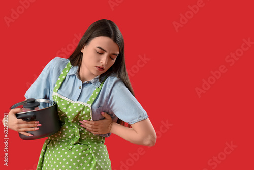 Young housewife with cookin...