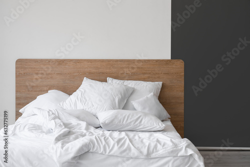 Fototapeta Naklejka Na Ścianę i Meble -  Interior of light bedroom with comfortable double bed and white pillows